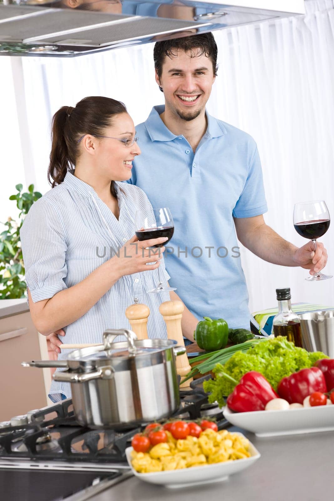 Cooking - happy couple together in modern kitchen