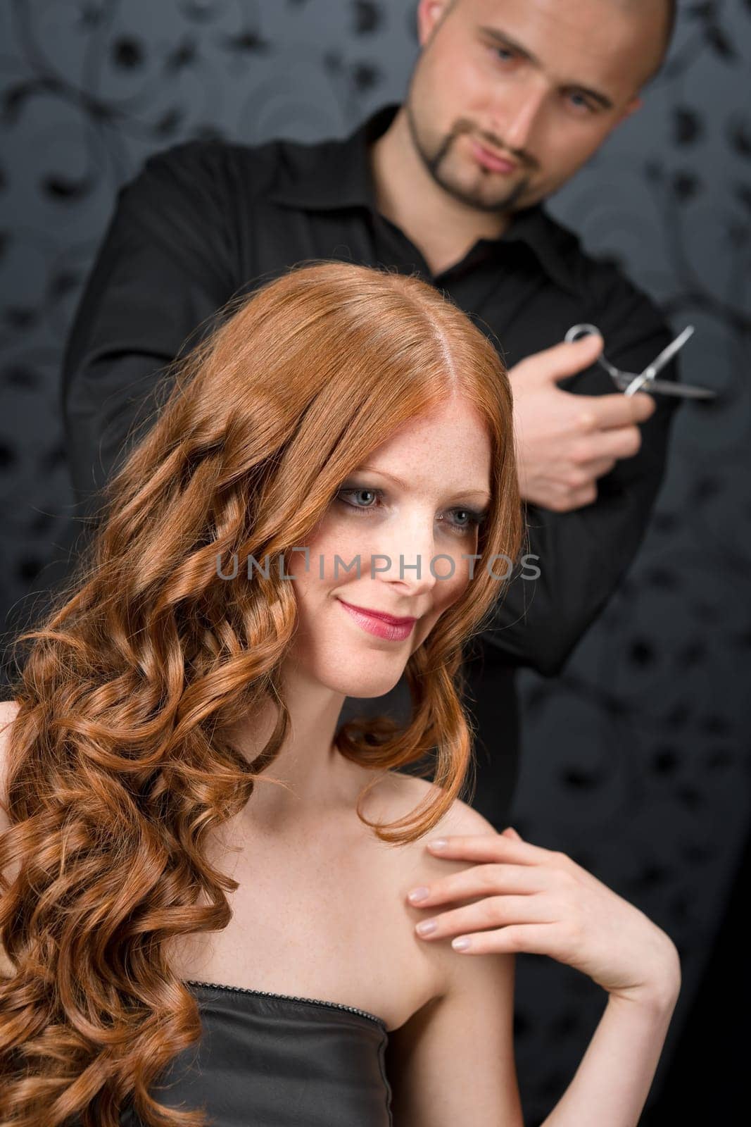 Professional hairdresser with fashion model at luxury salon