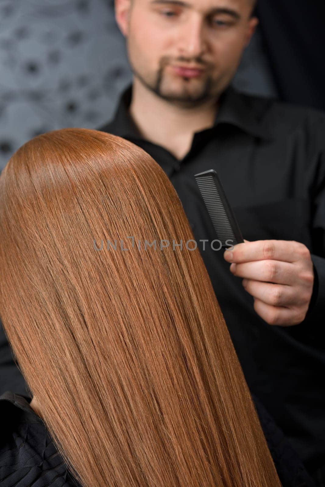 Professional hairdresser with fashion model at luxury salon