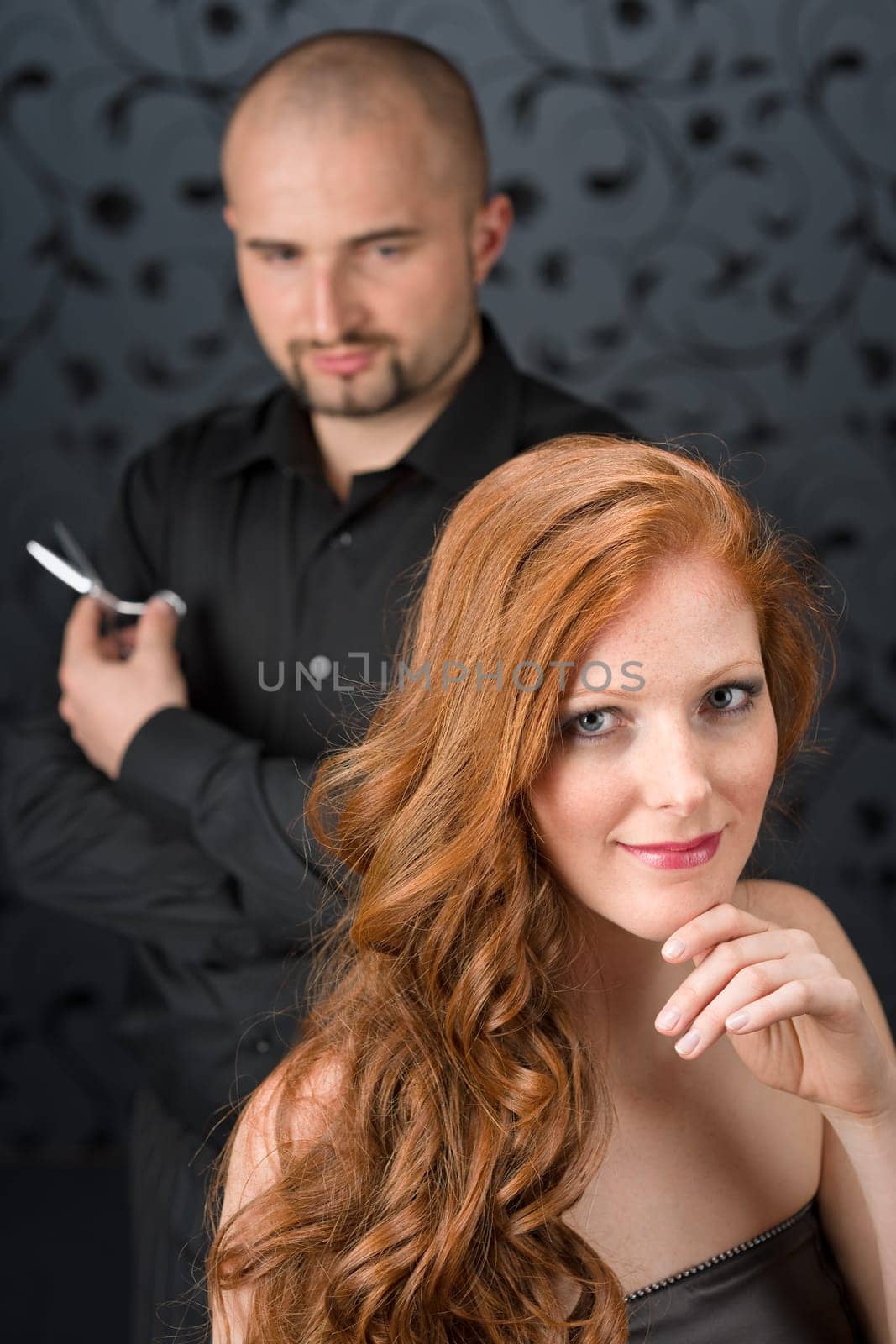 Professional hairdresser with fashion model at luxury salon