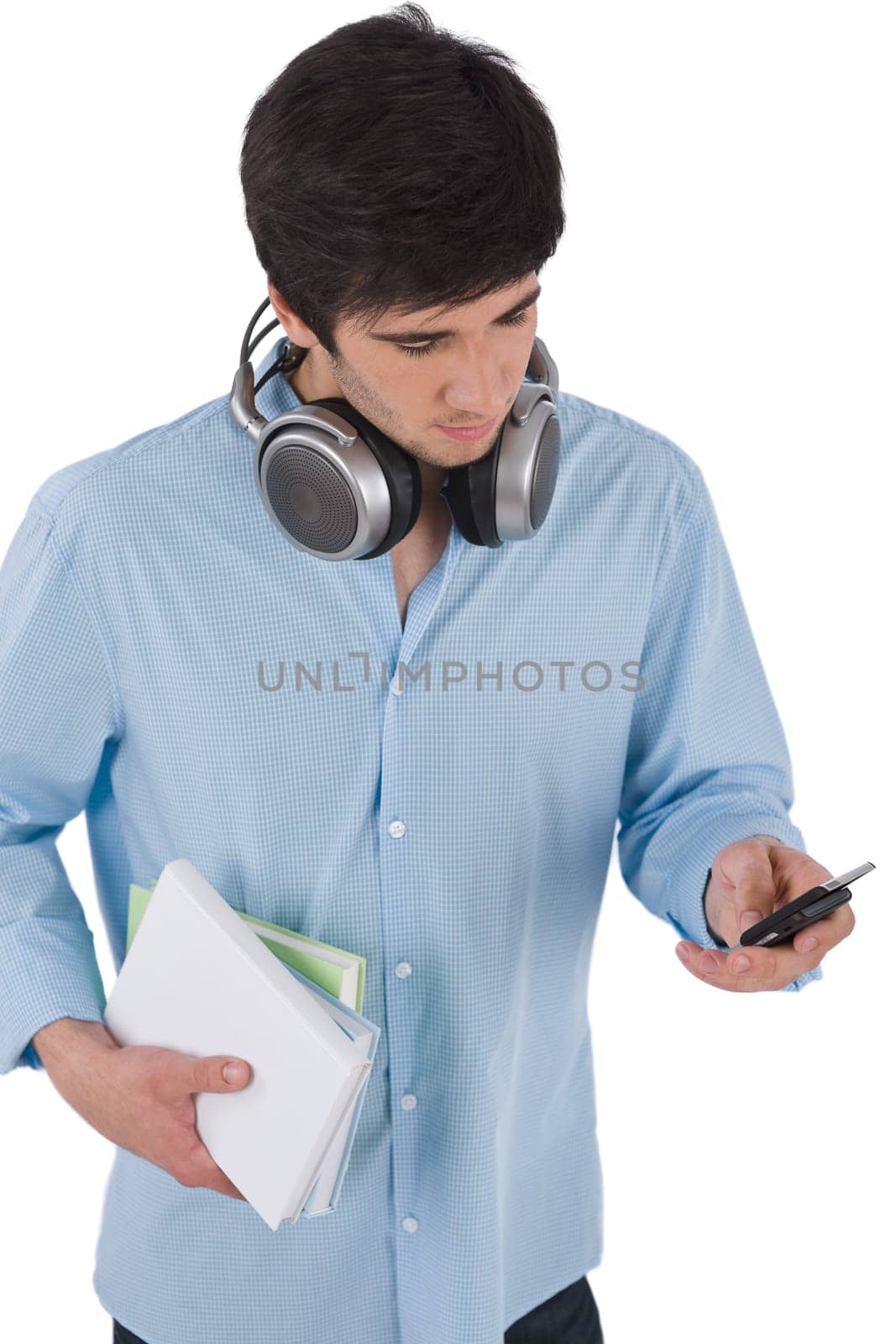 Male student sending text message holding books