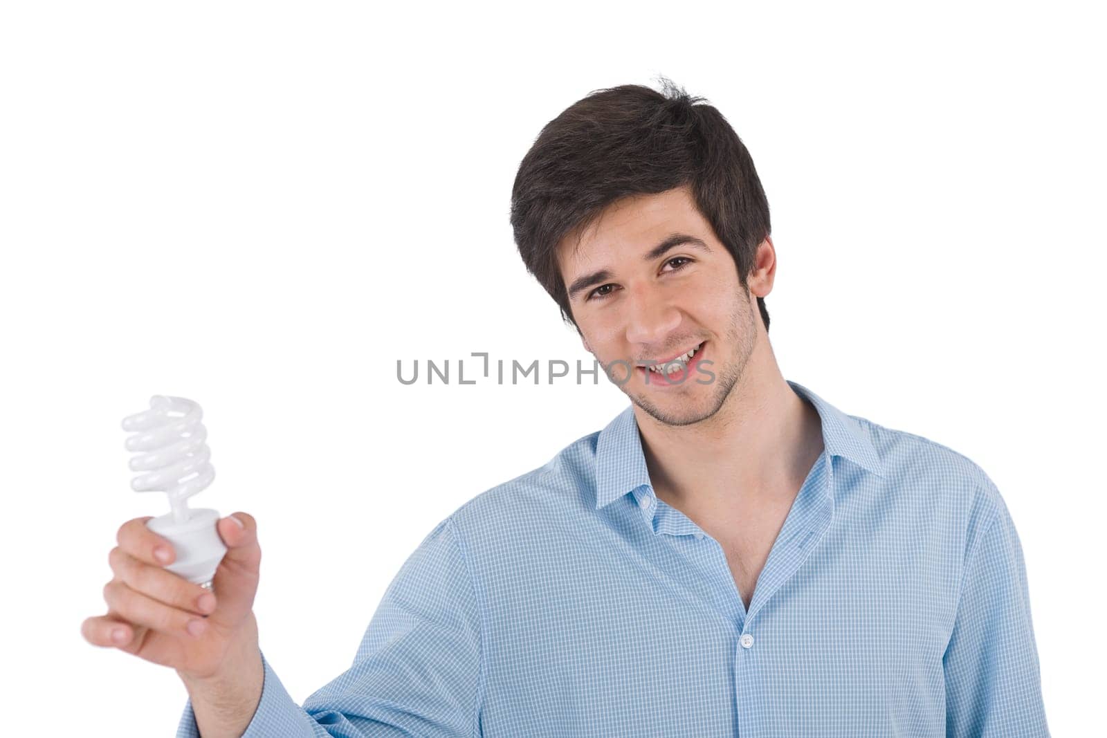 Smiling young man holding energy saving light bulb