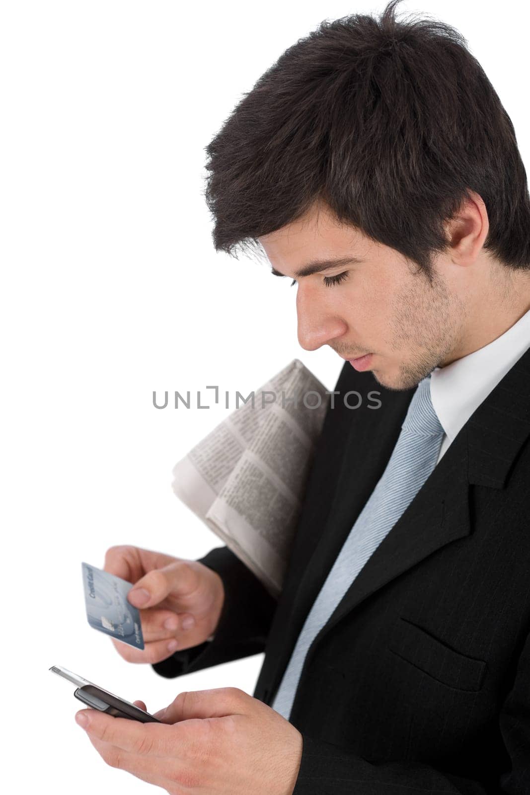 Young businessman holding mobile phone and credit card
