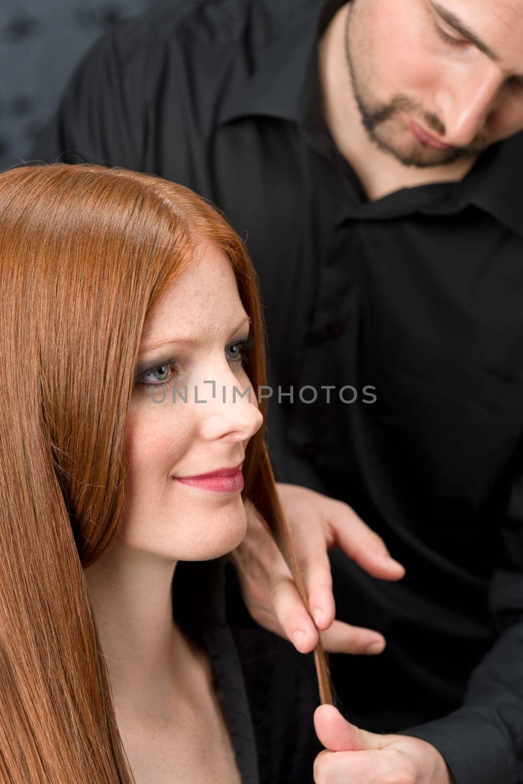 Professional hairdresser with fashion model at luxury salon