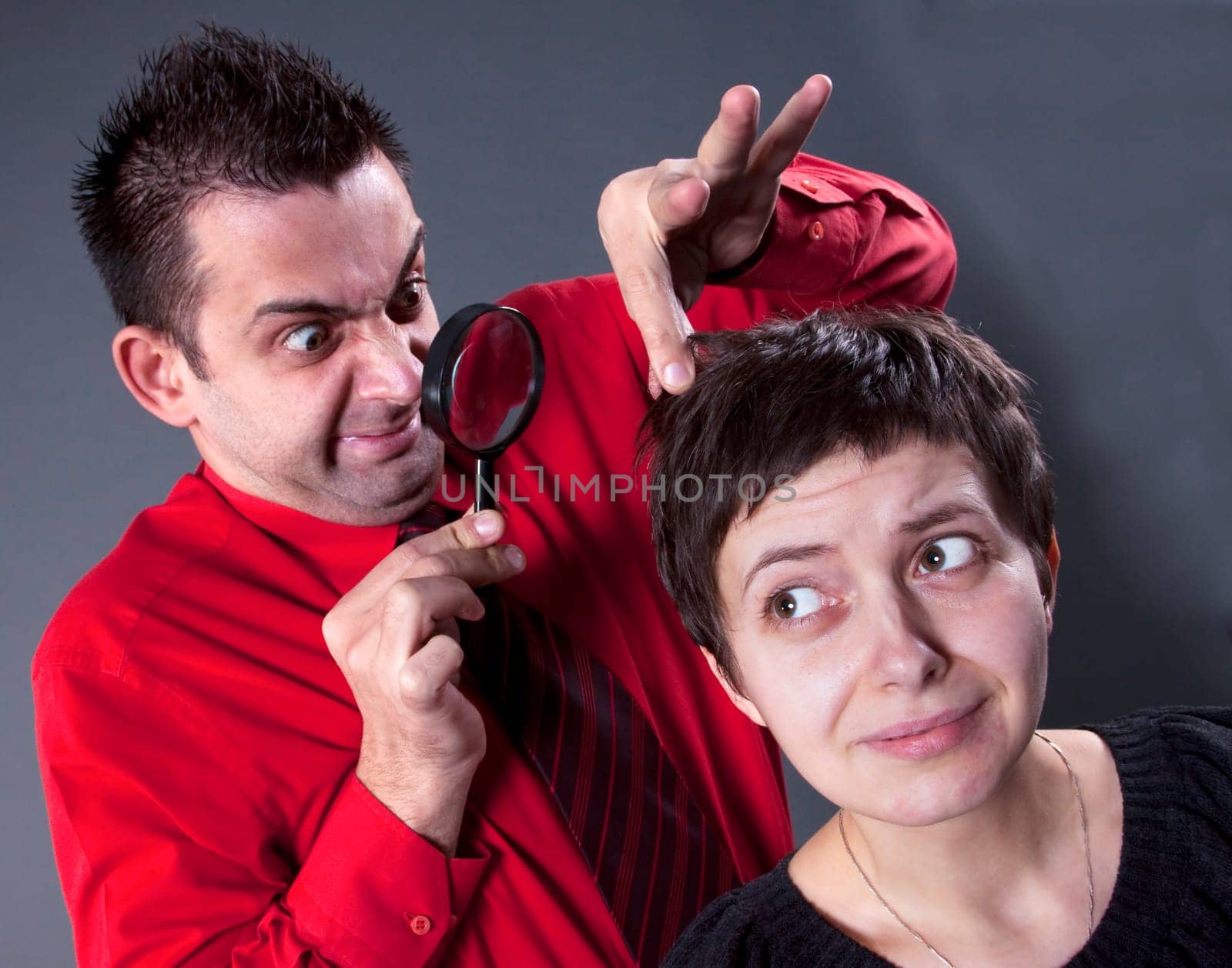 Woman examining mans hair