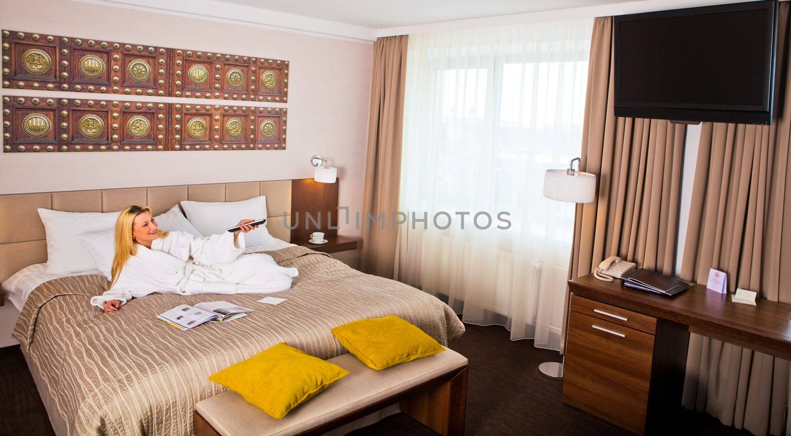 Woman Lying on Bed watching TV