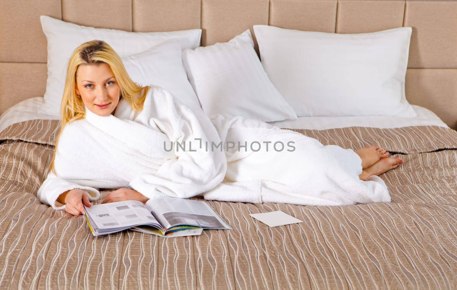 Woman Lying on Bed watching TV