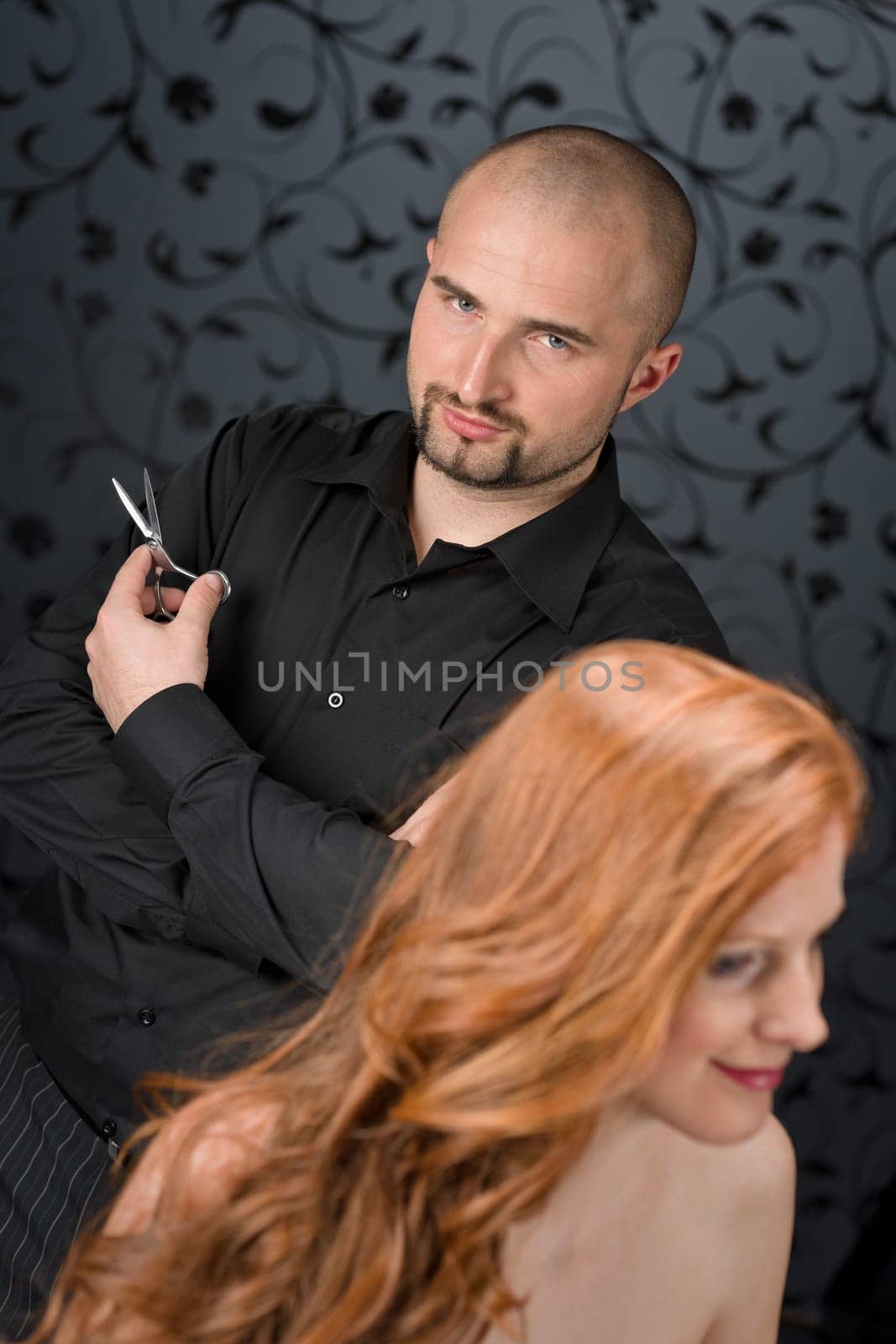 Professional hairdresser with fashion model at luxury salon