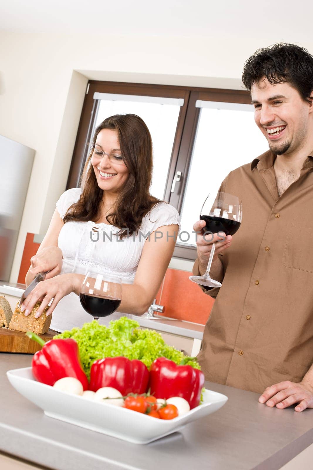 Cooking - happy couple together in modern kitchen