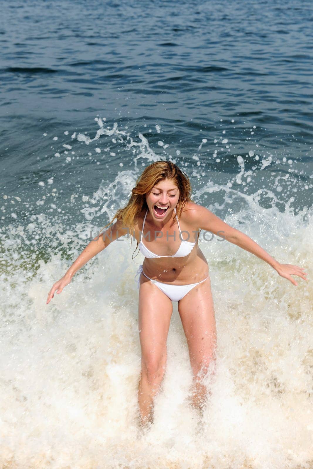 Woman is surprised by wave