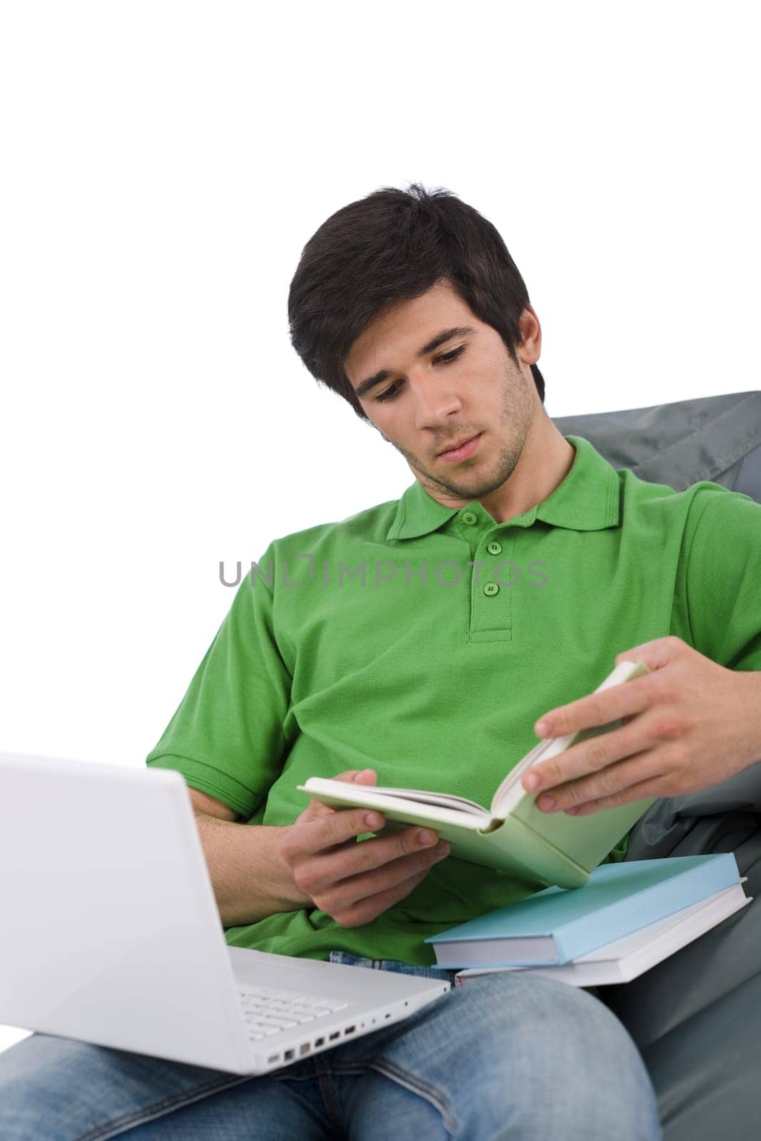 Student - Young man with laptop reading book