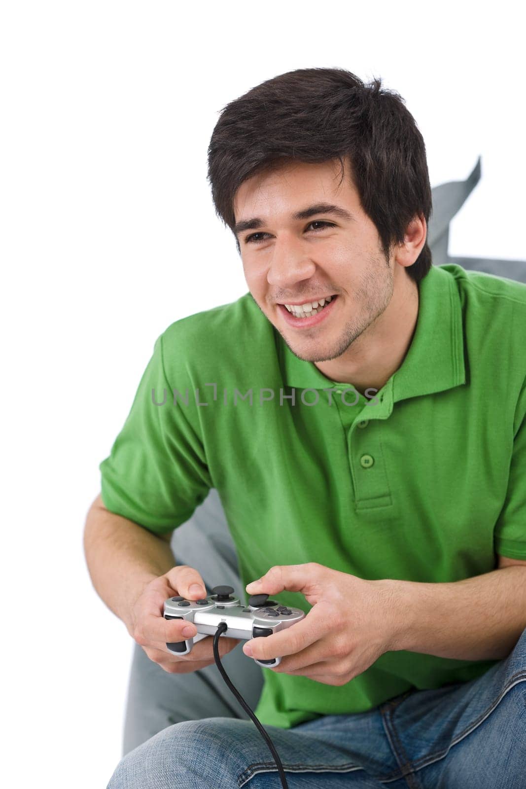 Young happy man playing video game with control pad