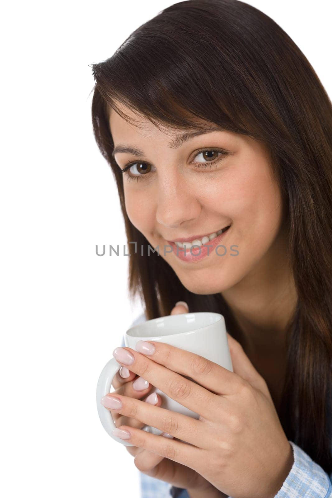 Happy young woman with coffee in pajamas