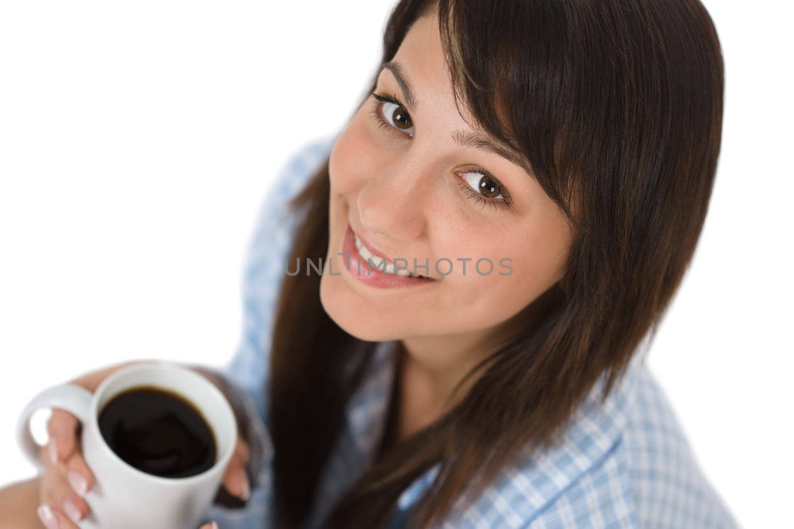 Happy young woman with coffee in pajamas