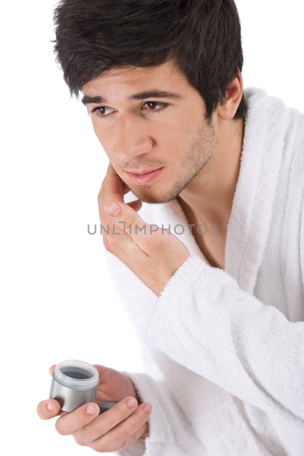 Facial care - man apply moisturizer