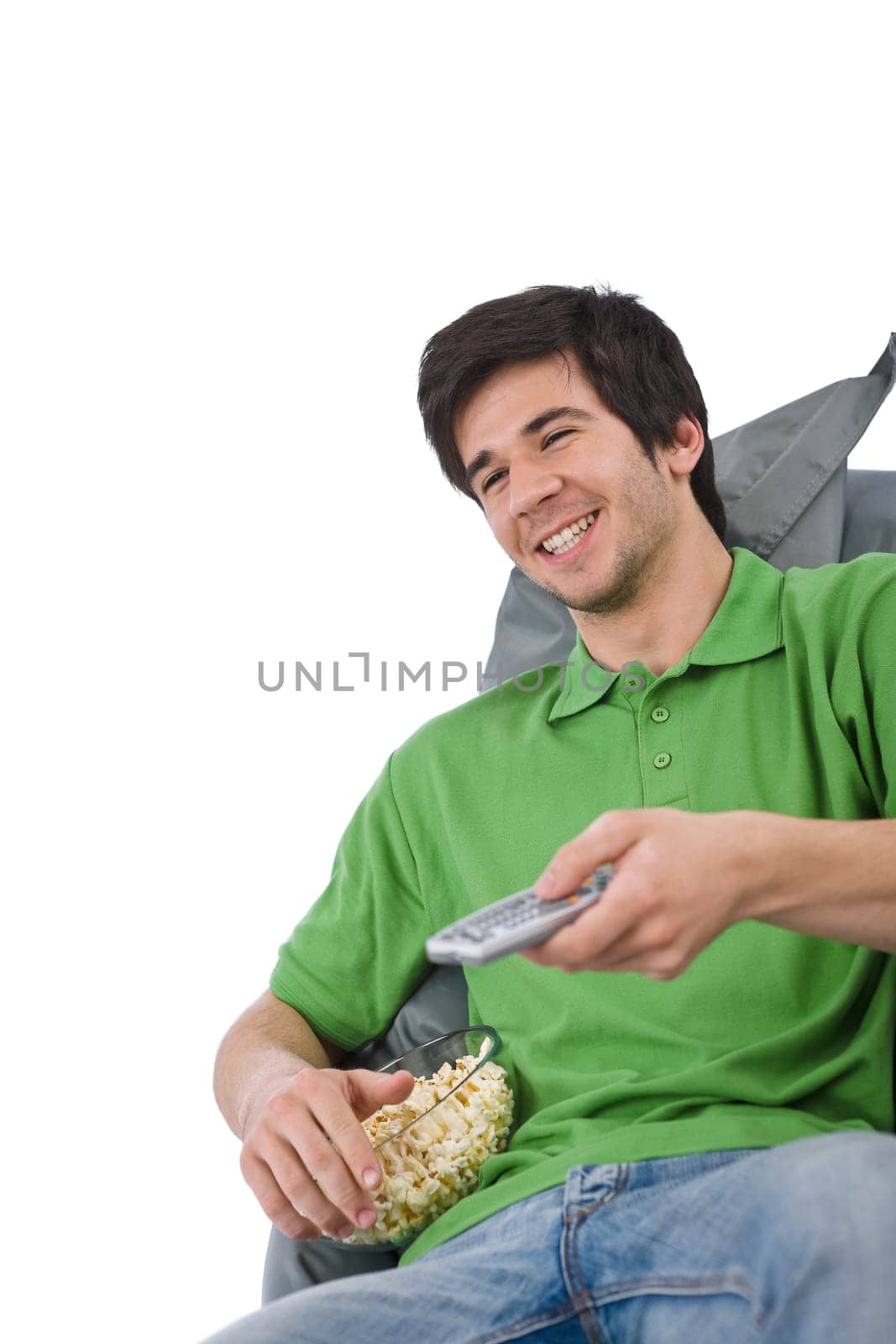 Young man holding remote control watch television