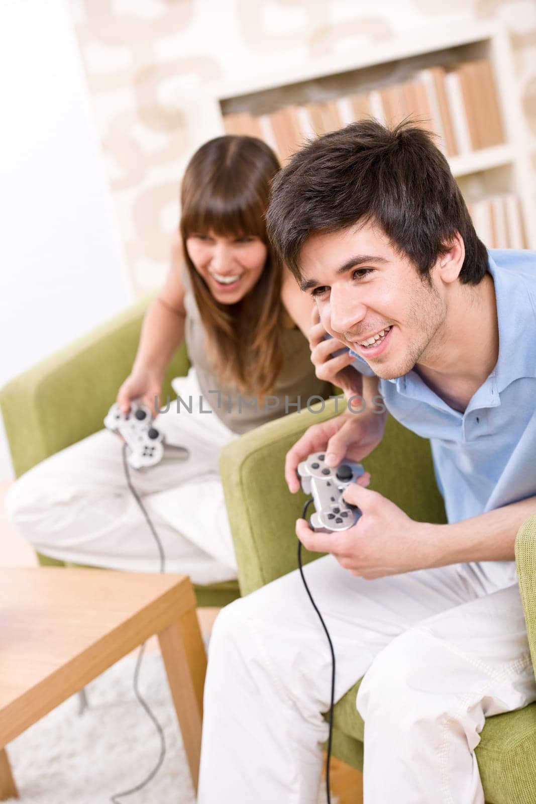 Students - happy teenagers playing video game