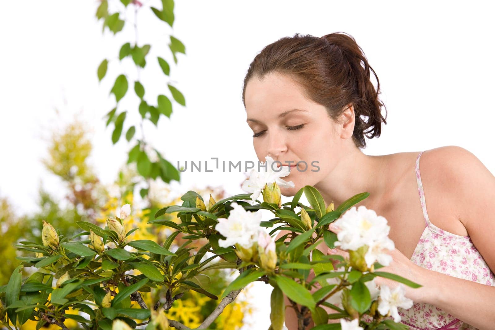Gardening - Woman smelling blossom flower