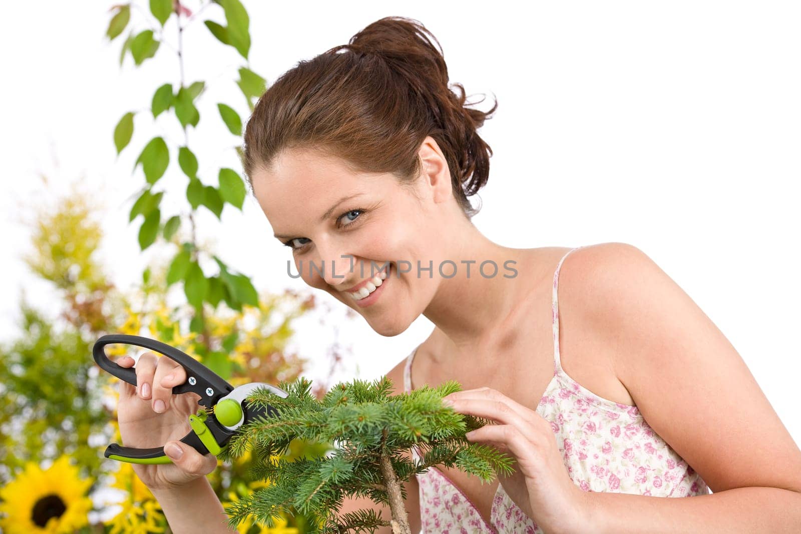 Gardening - Smiling woman cutting tree