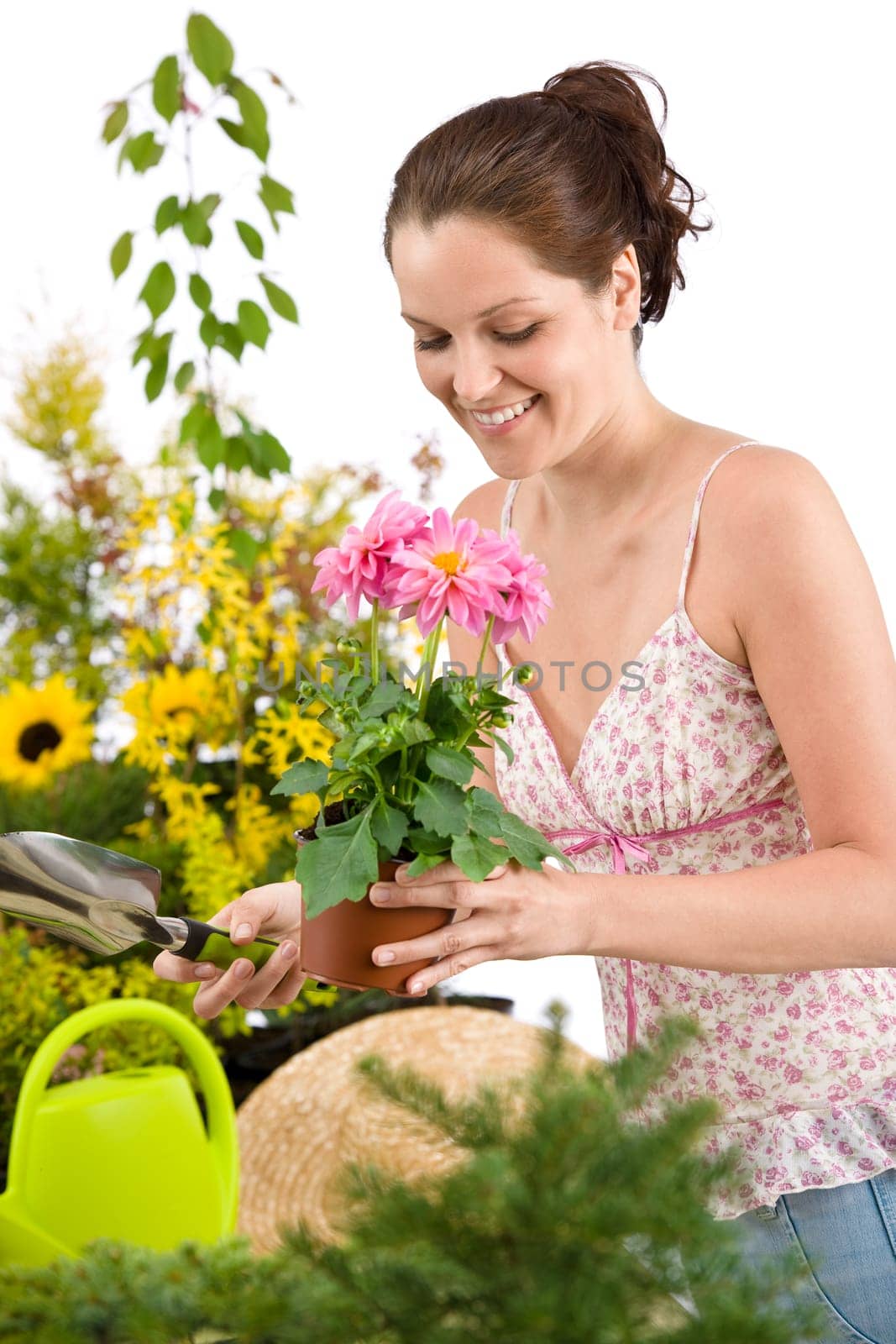 Gardening - woman holding flower pot and shovel