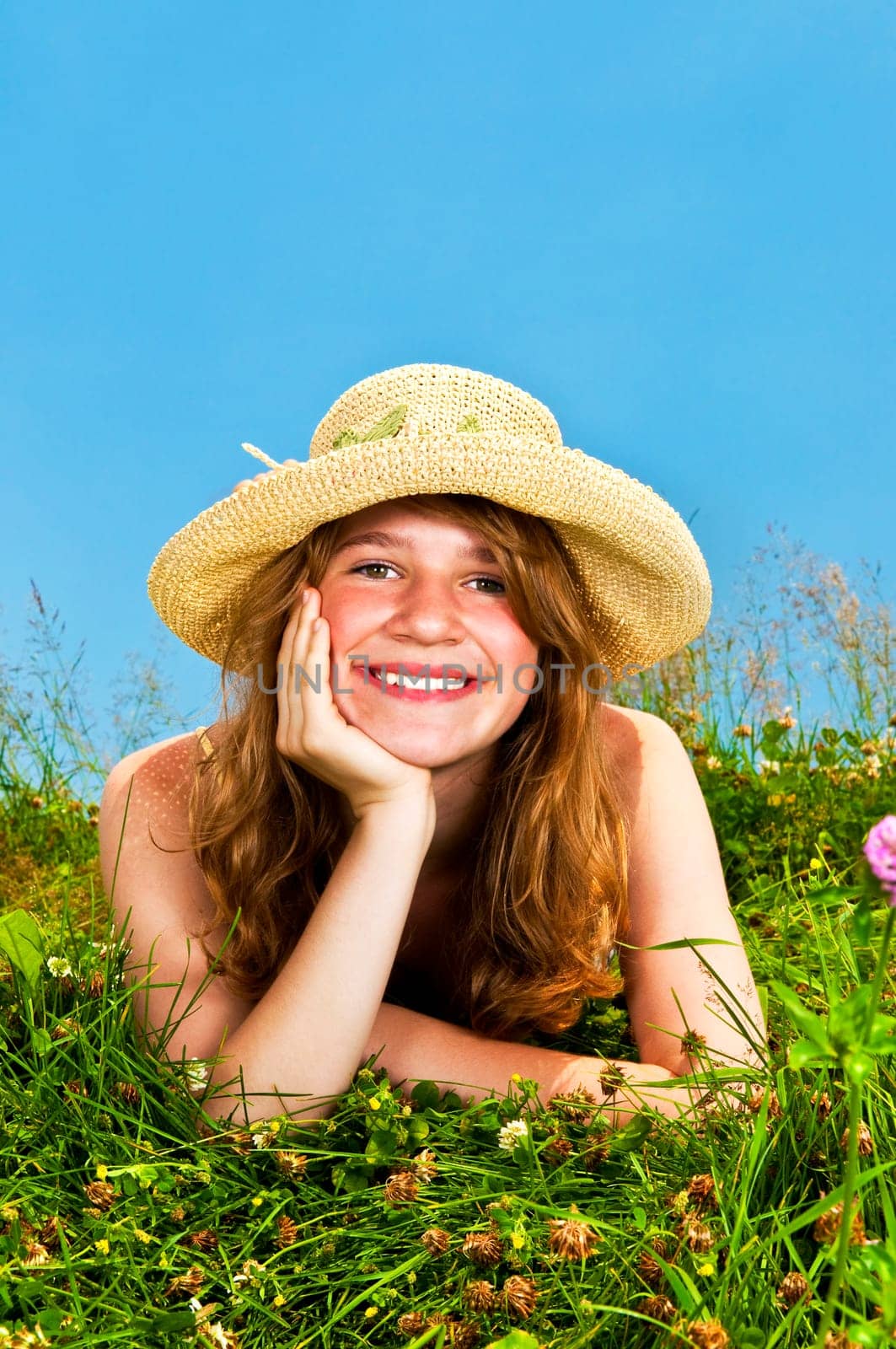 Young girl laying in meadow