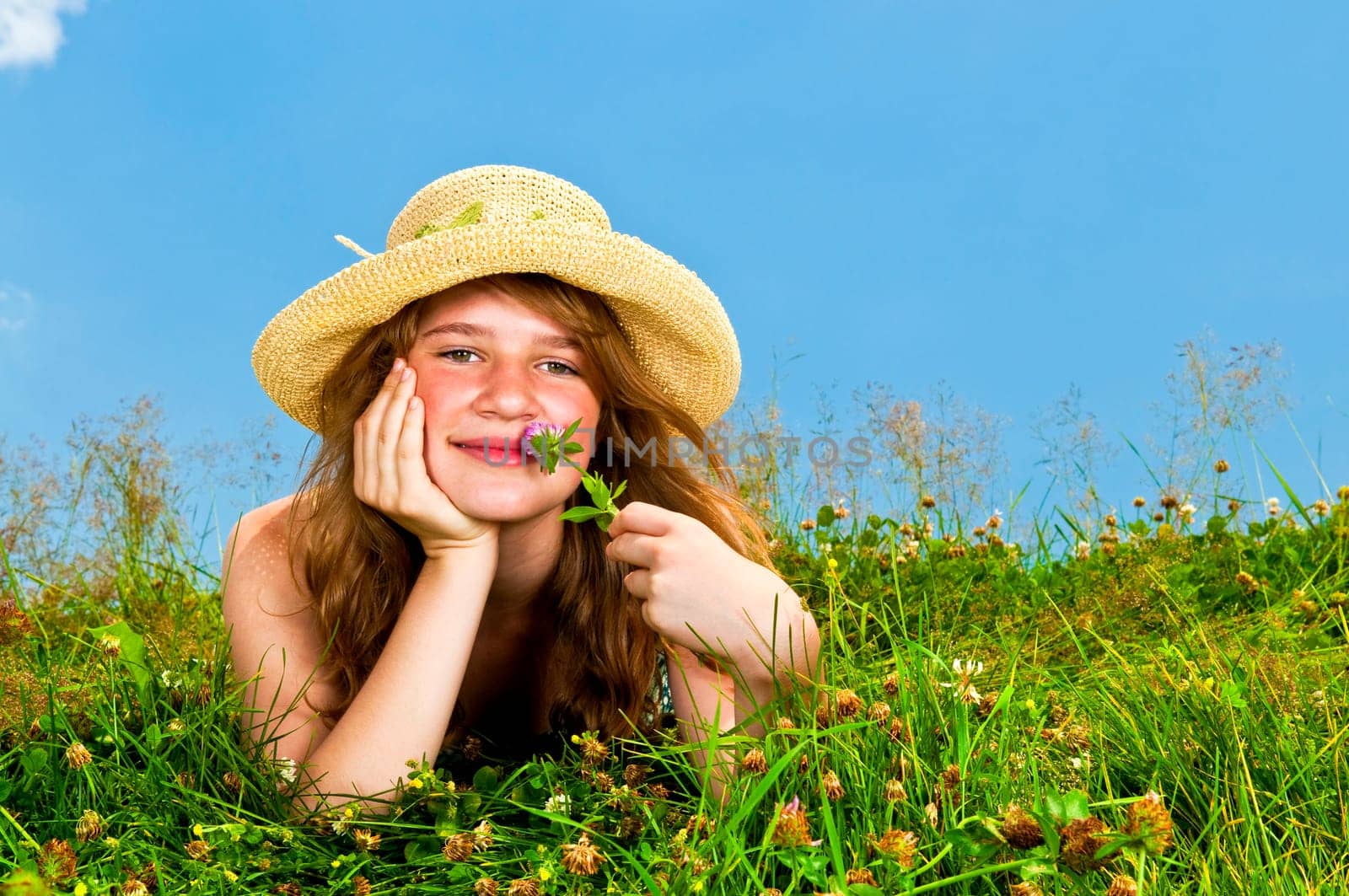 Young girl laying in meadow