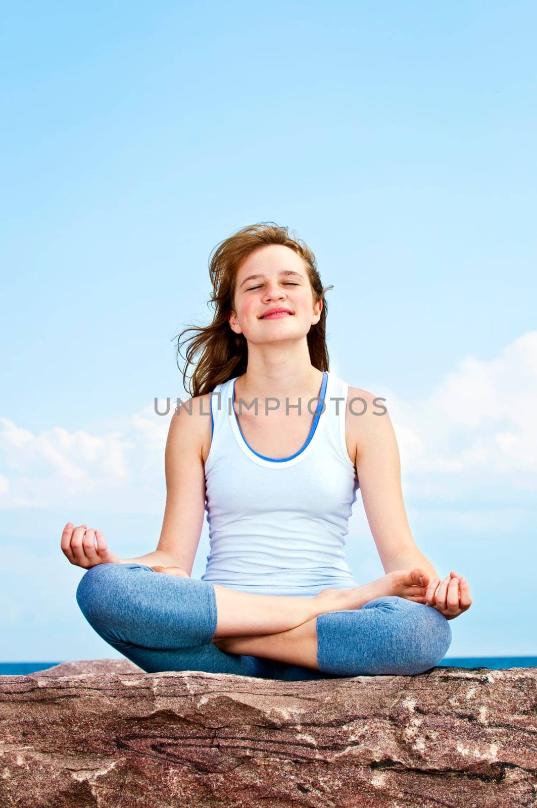 Young girl meditating outdoors