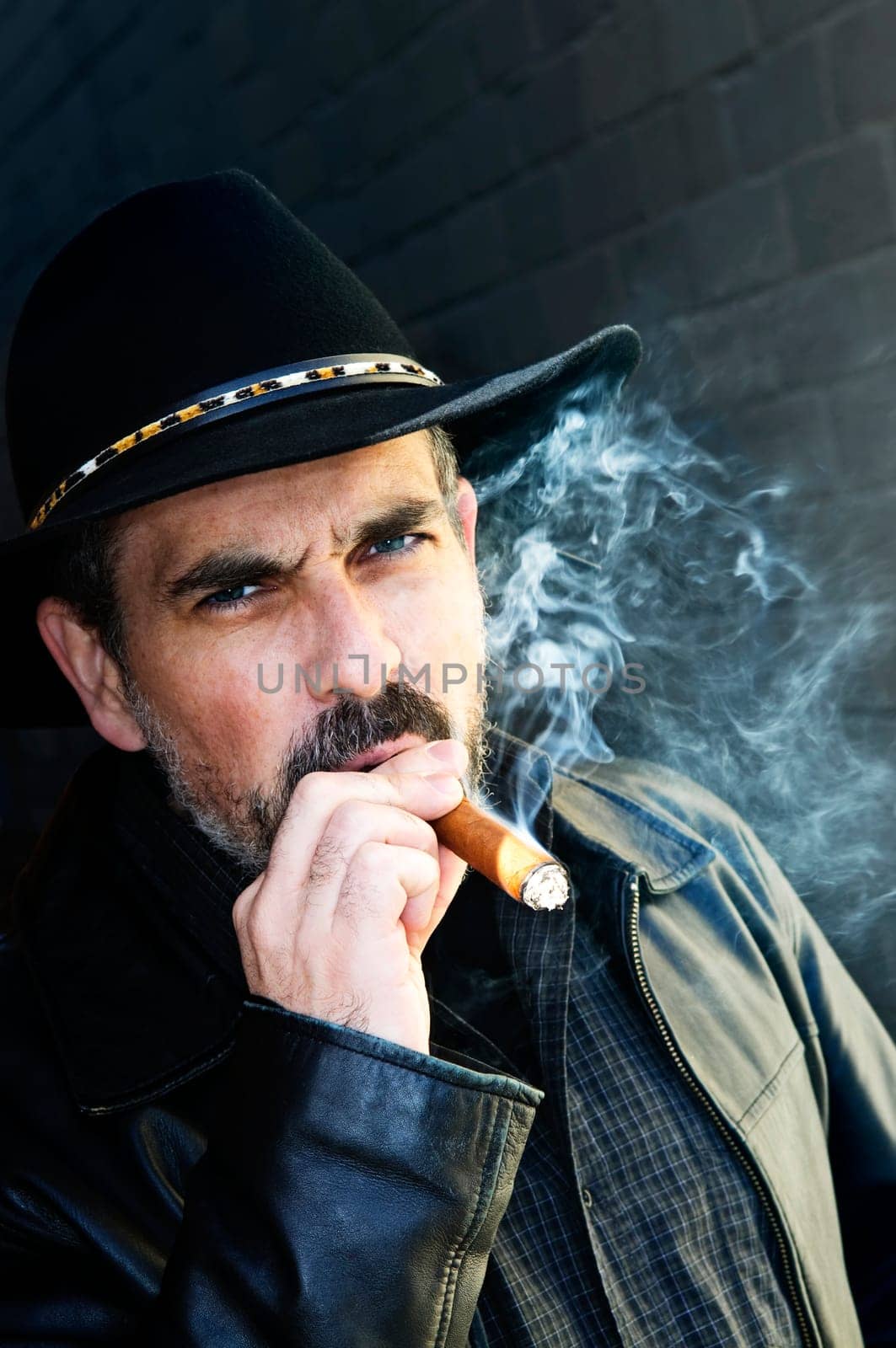 Bearded man smoking cigar