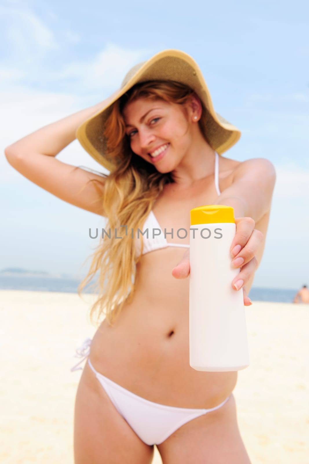 Woman with sunscreen on the beach