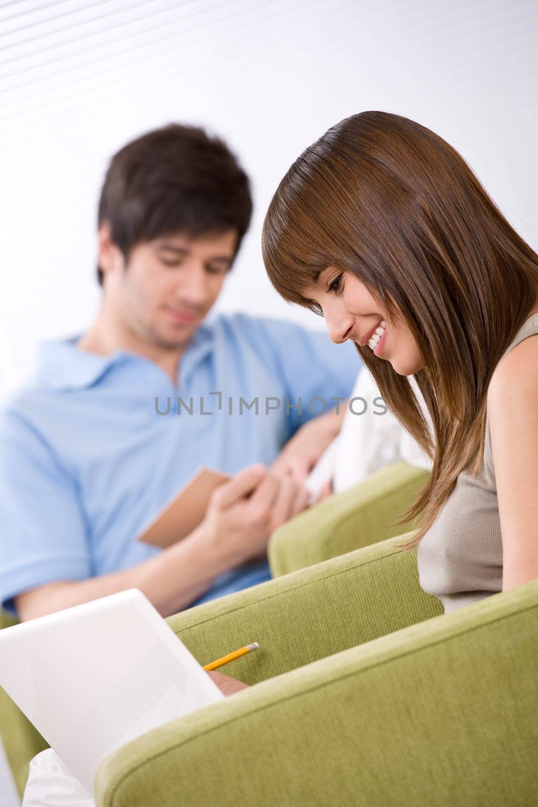 Student - two teenager reading book in lounge