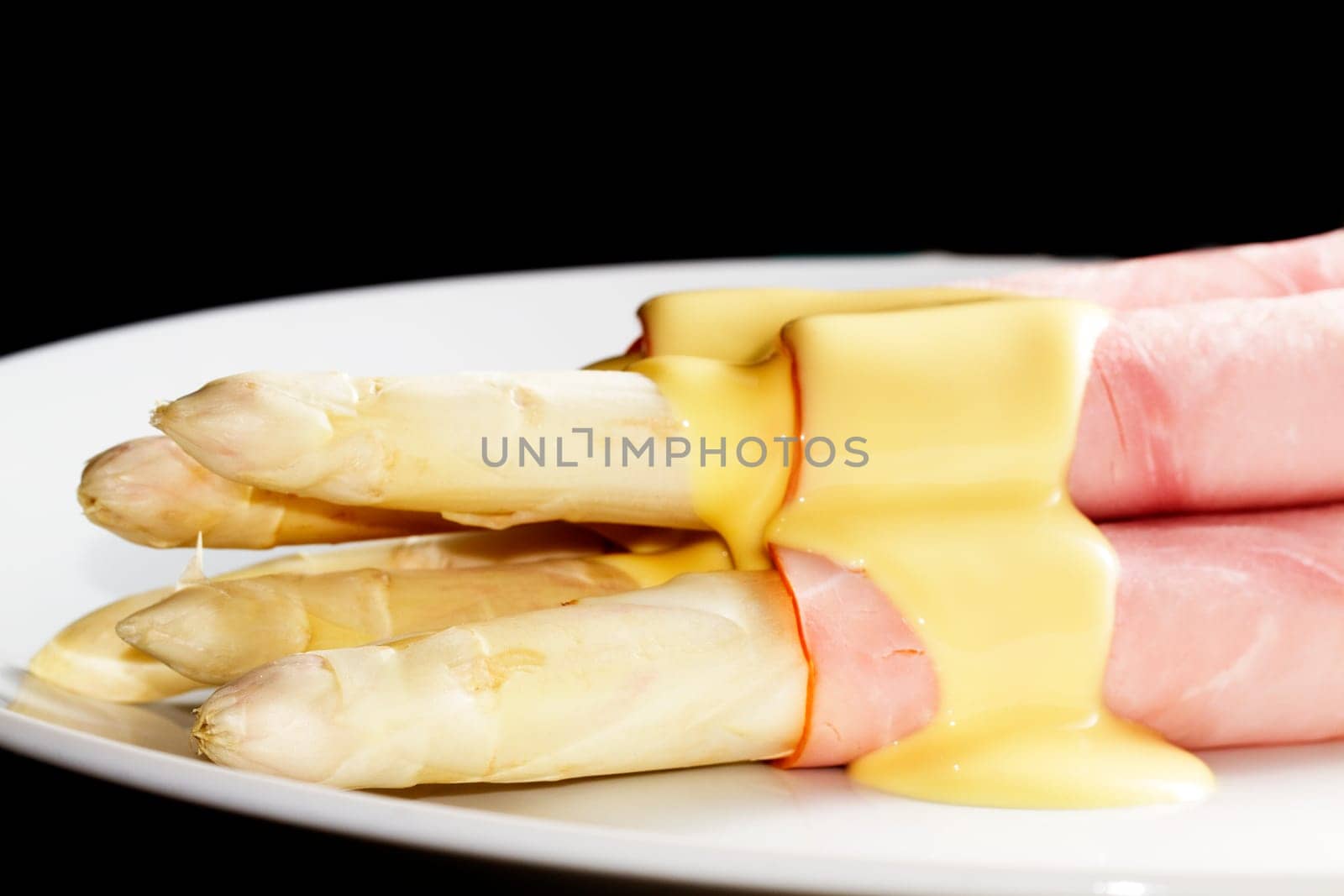 Plate of asparagus before black
