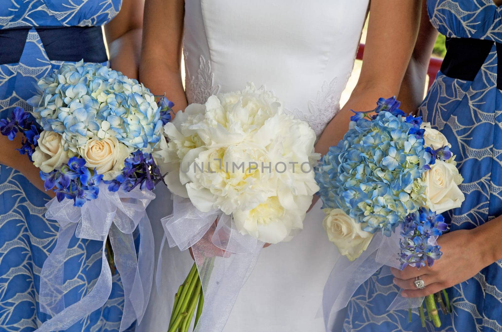 Bride and Two Bridesmaids Holding Bouque