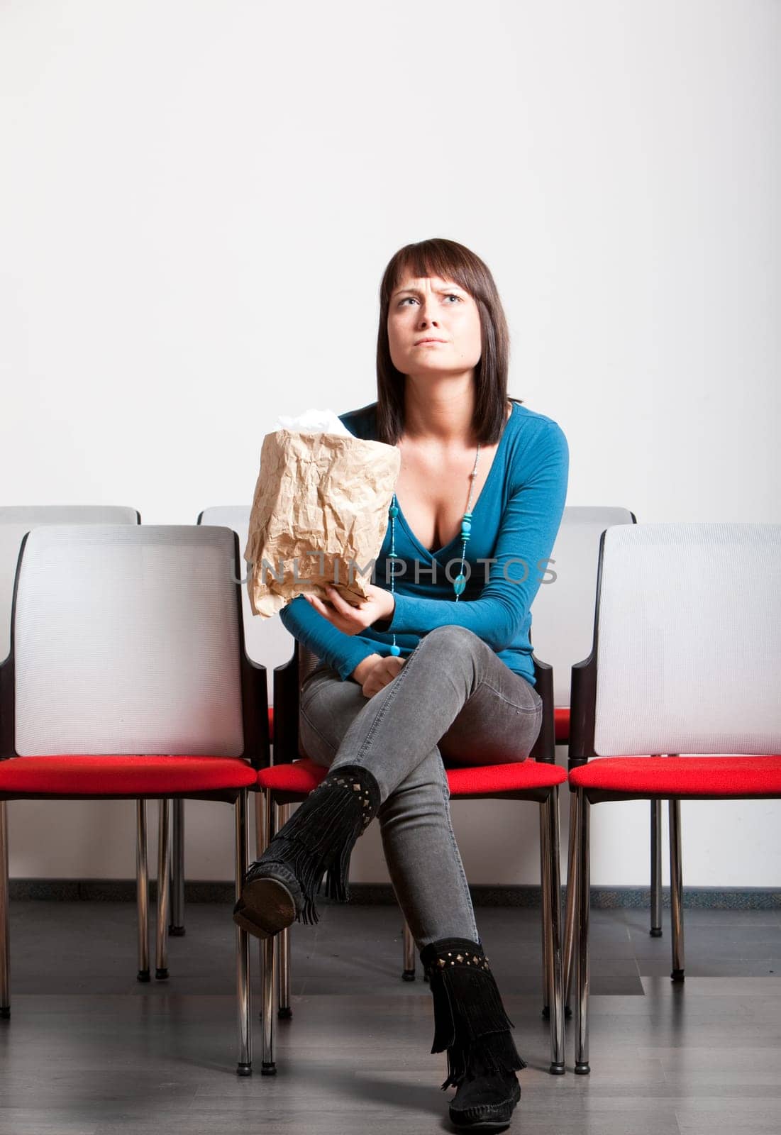sad young woman holding tissue on her face