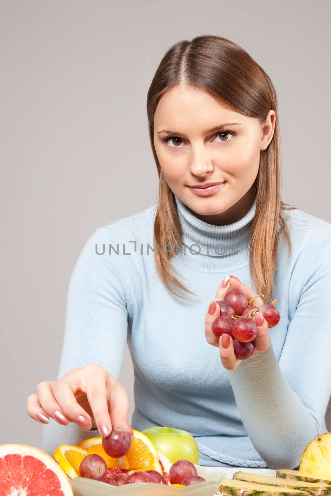 woman with red grapes