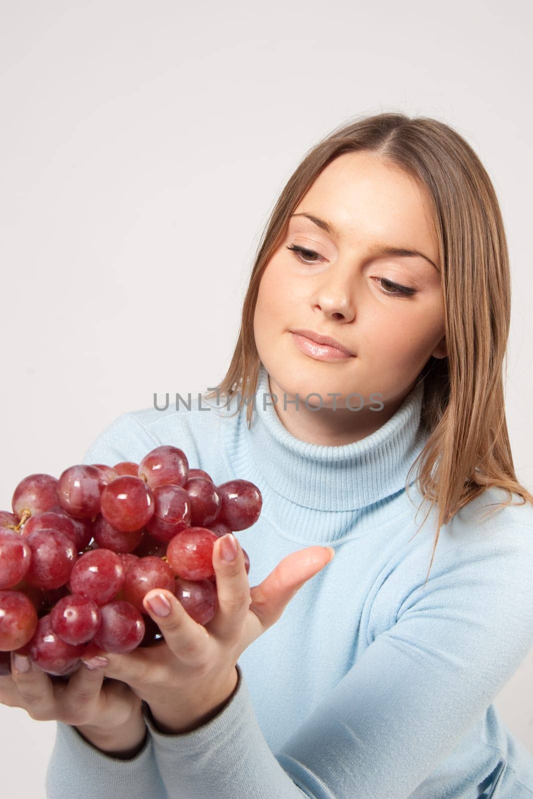 woman with red grapes