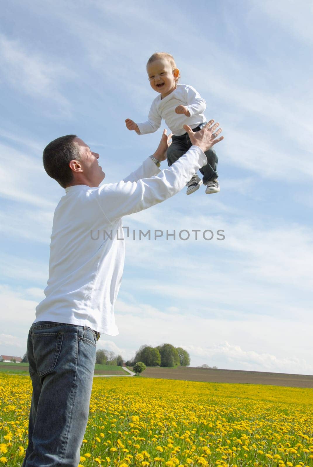 Proud father -throwing child up-
