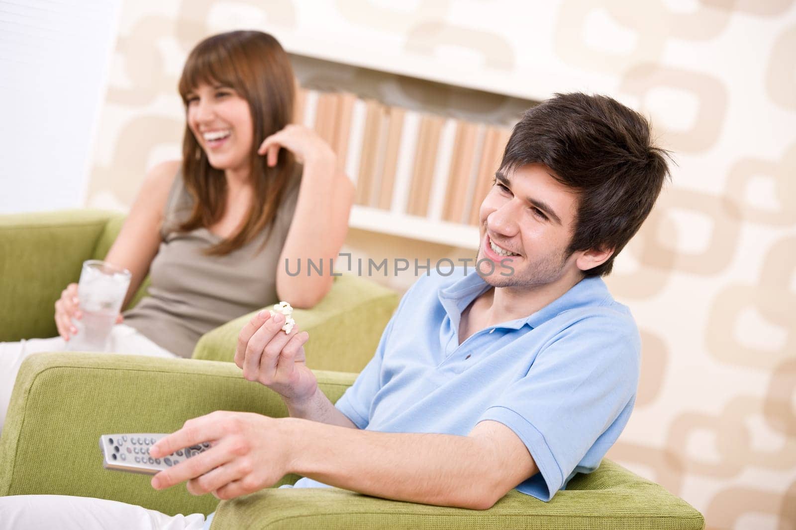 Student - happy teenagers watching television