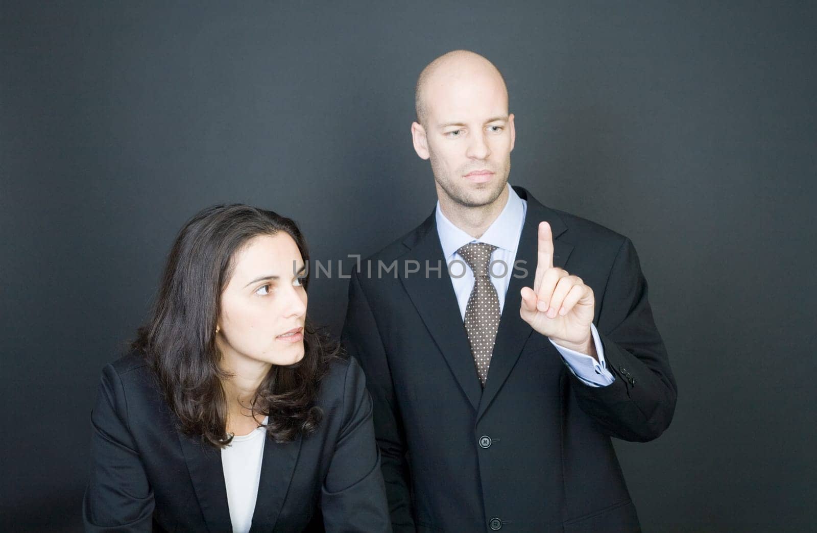 Business couple pressing virtual screen