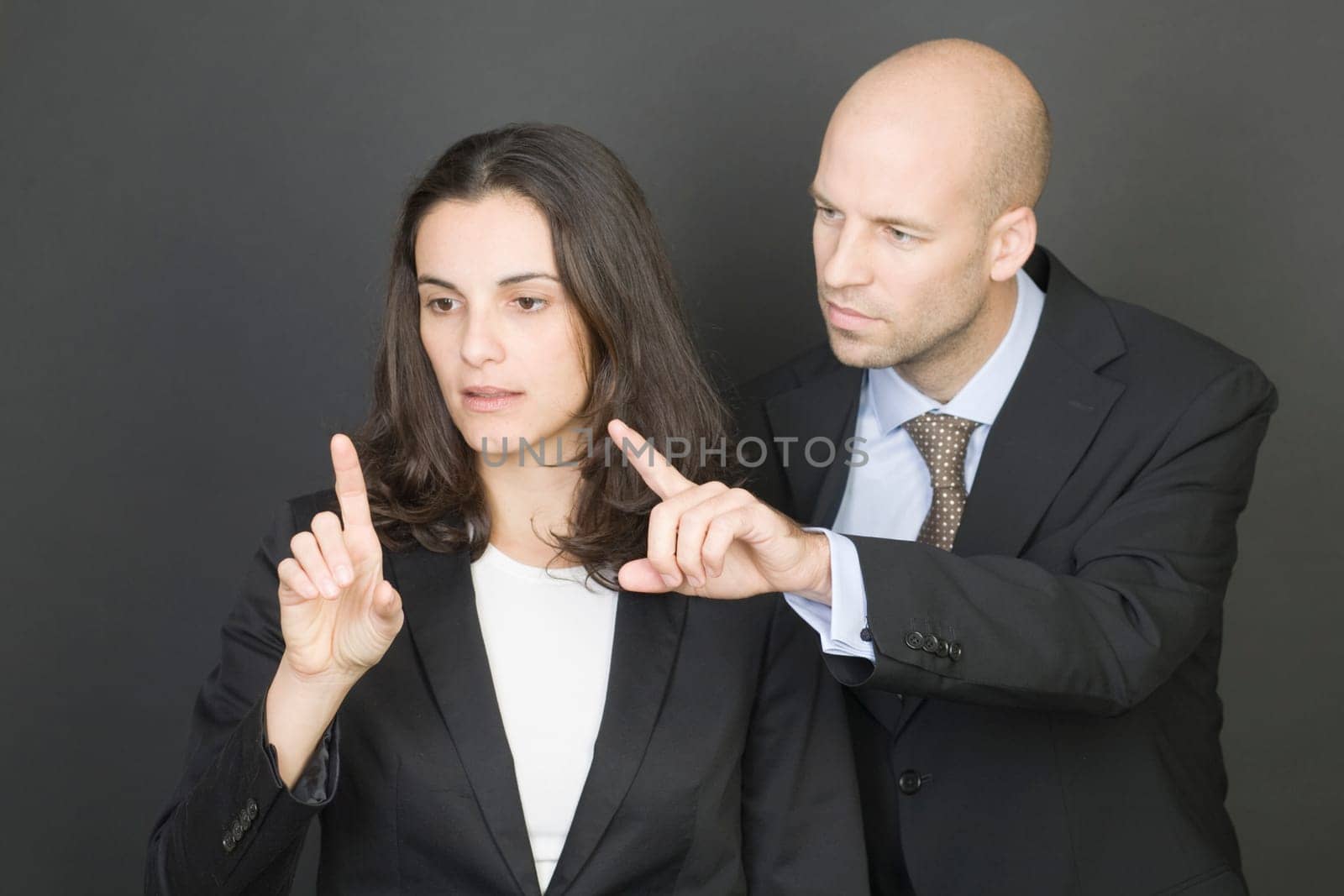 Business couple pressing virtual screen