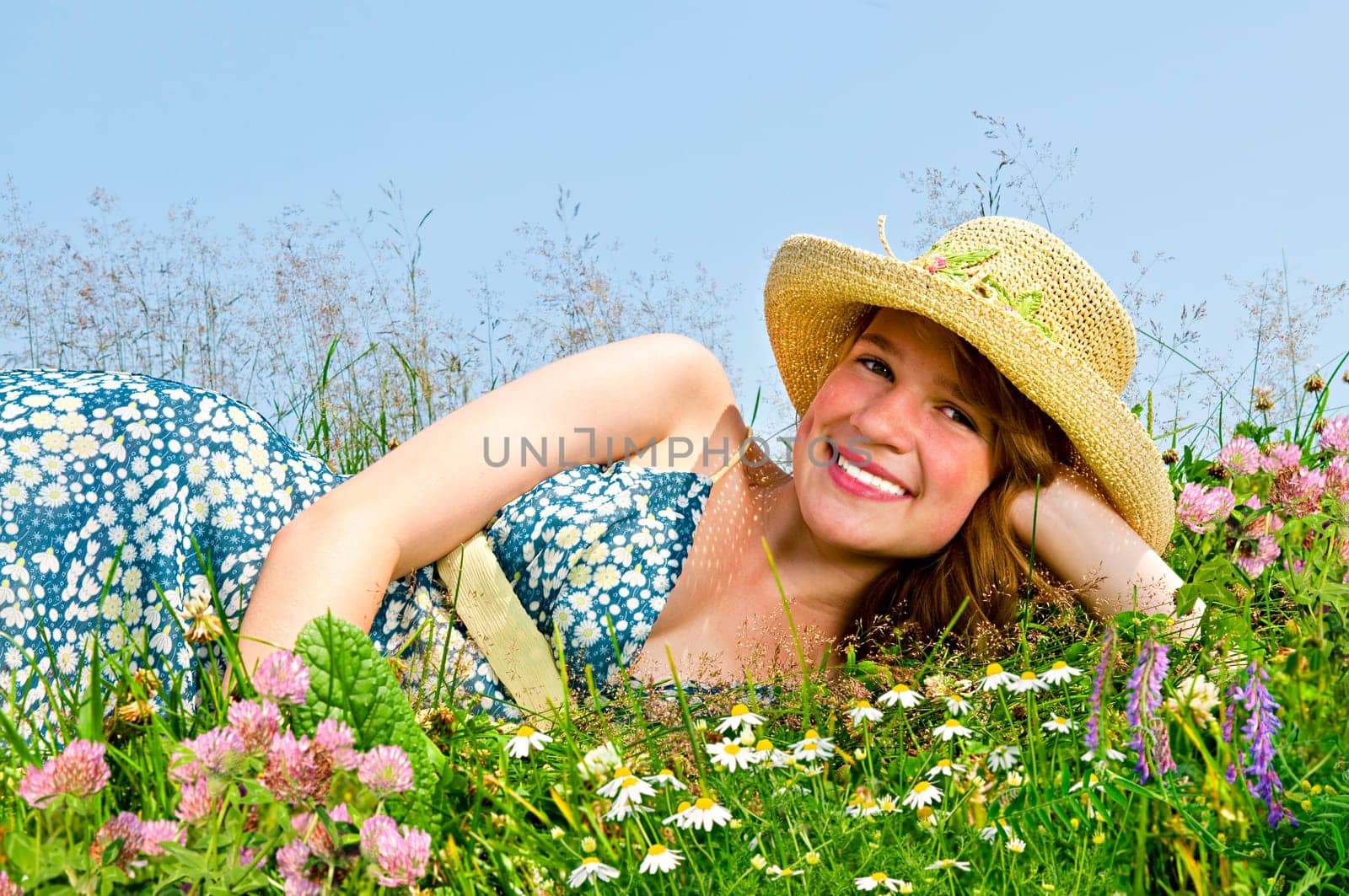 Young girl laying on meadow