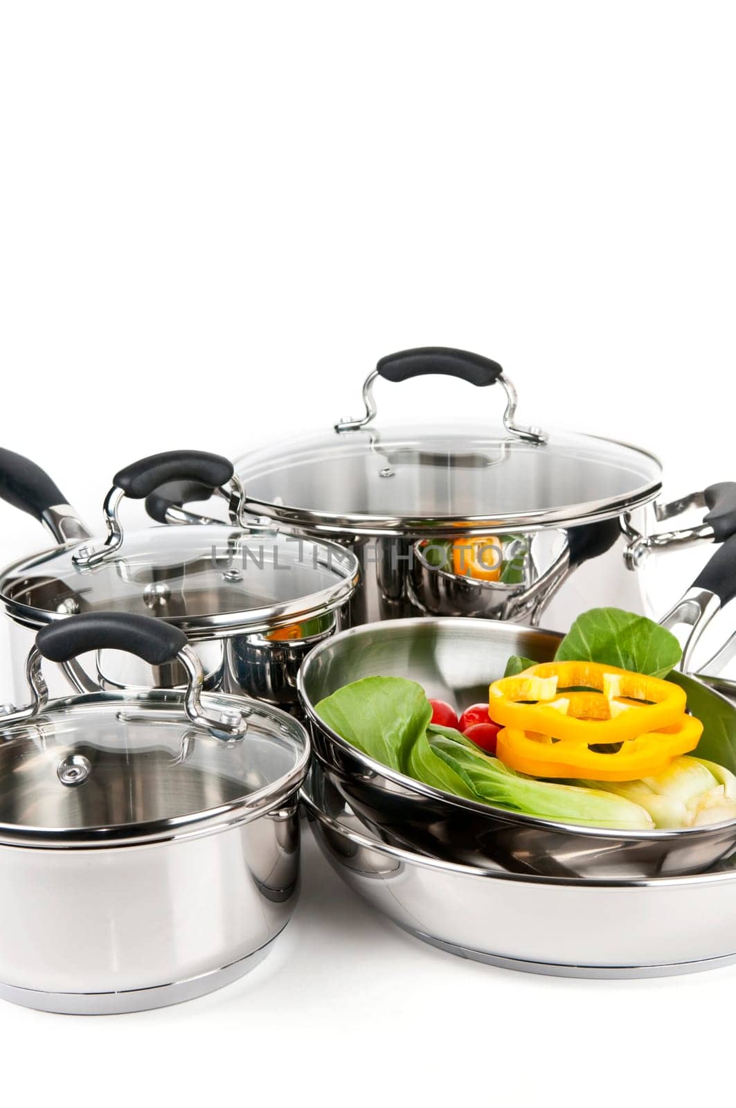 Stainless steel pots and pans with vegetables