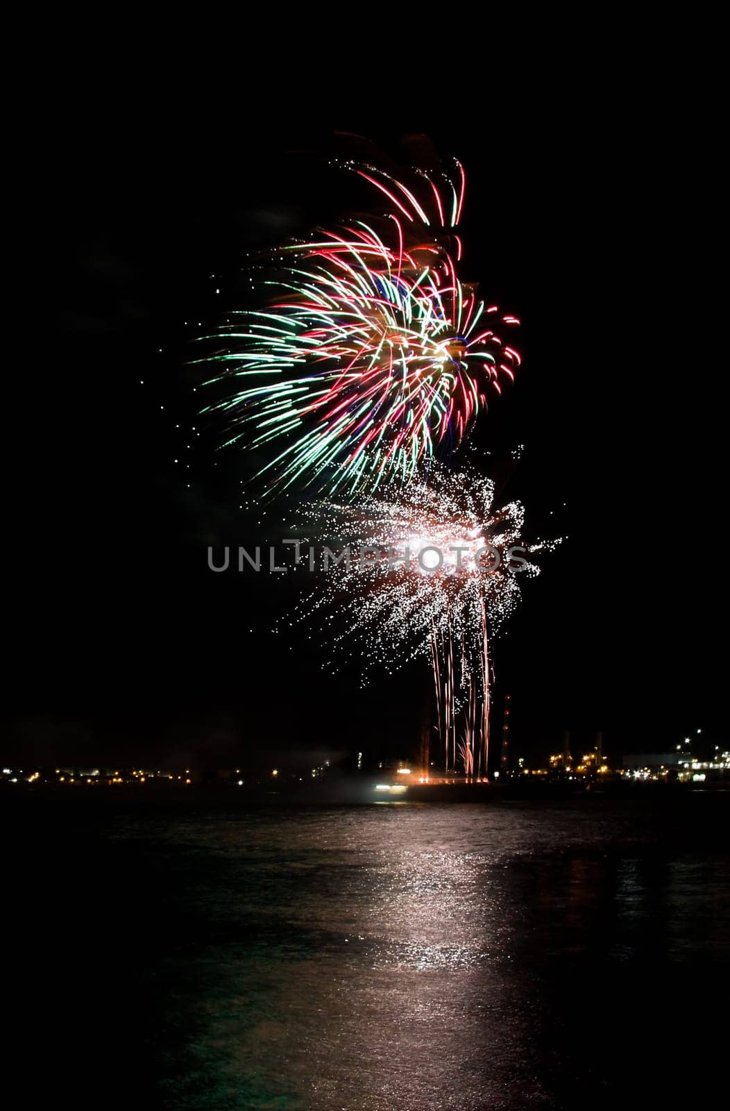 Red and green fireworks on the river