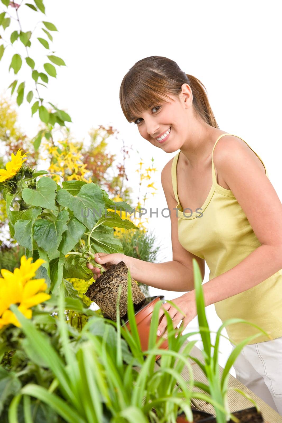 Gardening - smiling woman holding flower pot