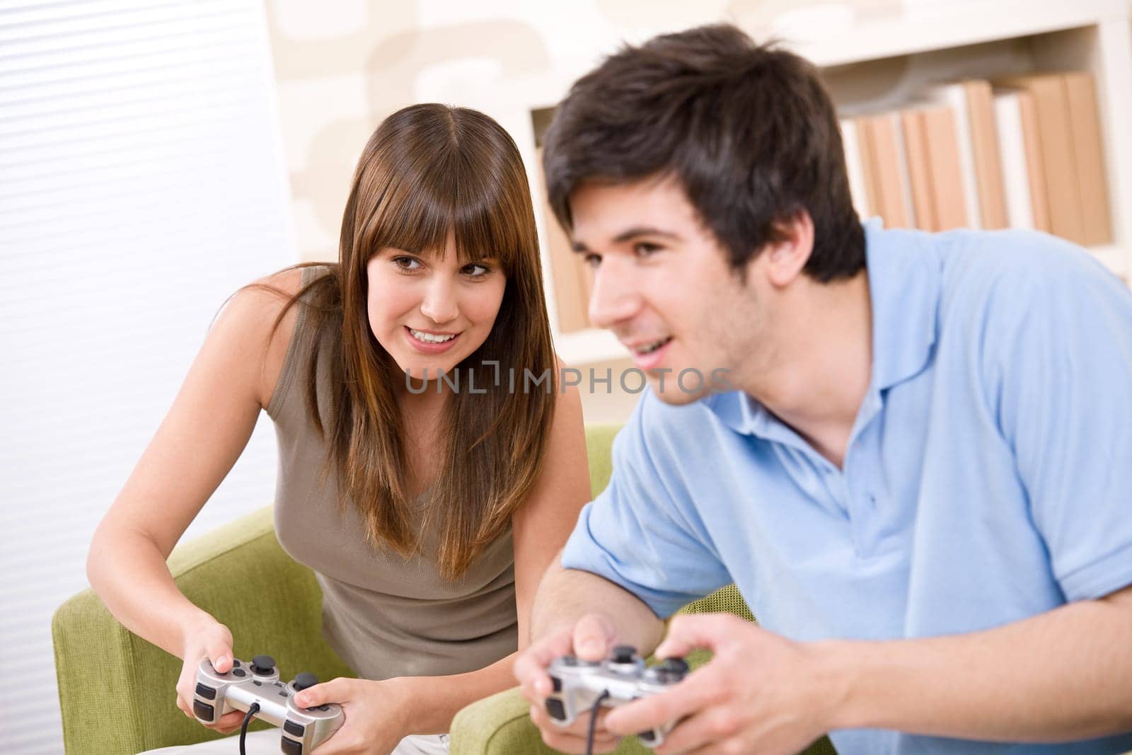 Student - happy teenagers playing video game