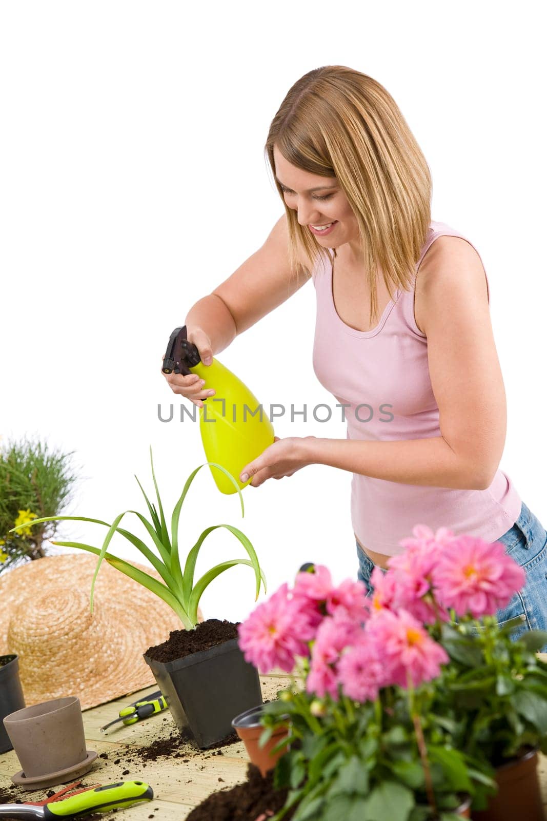 Gardening - woman sprinkling water to flowers