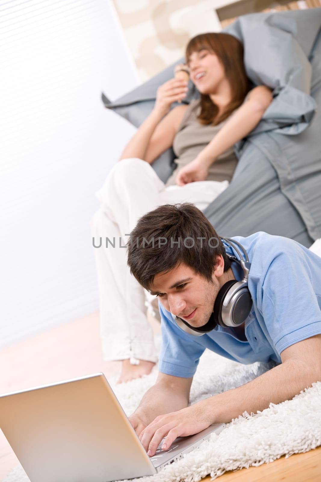 Student - Happy teenager with laptop and headphones