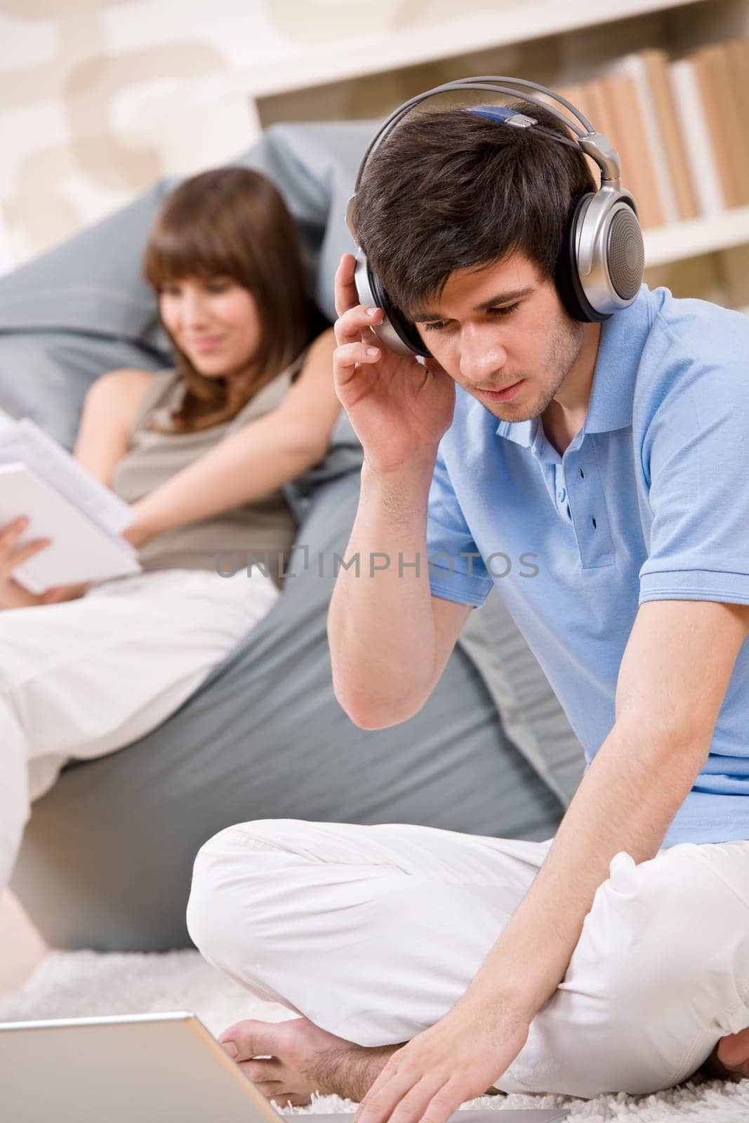 Student - Happy teenager with laptop and headphones
