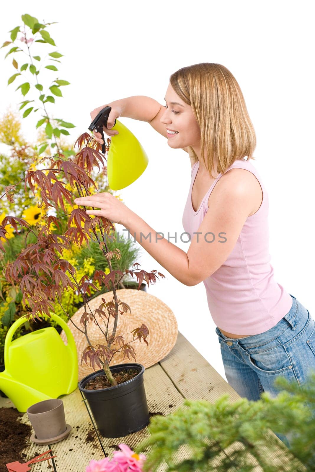 Gardening - woman sprinkling water to flowers