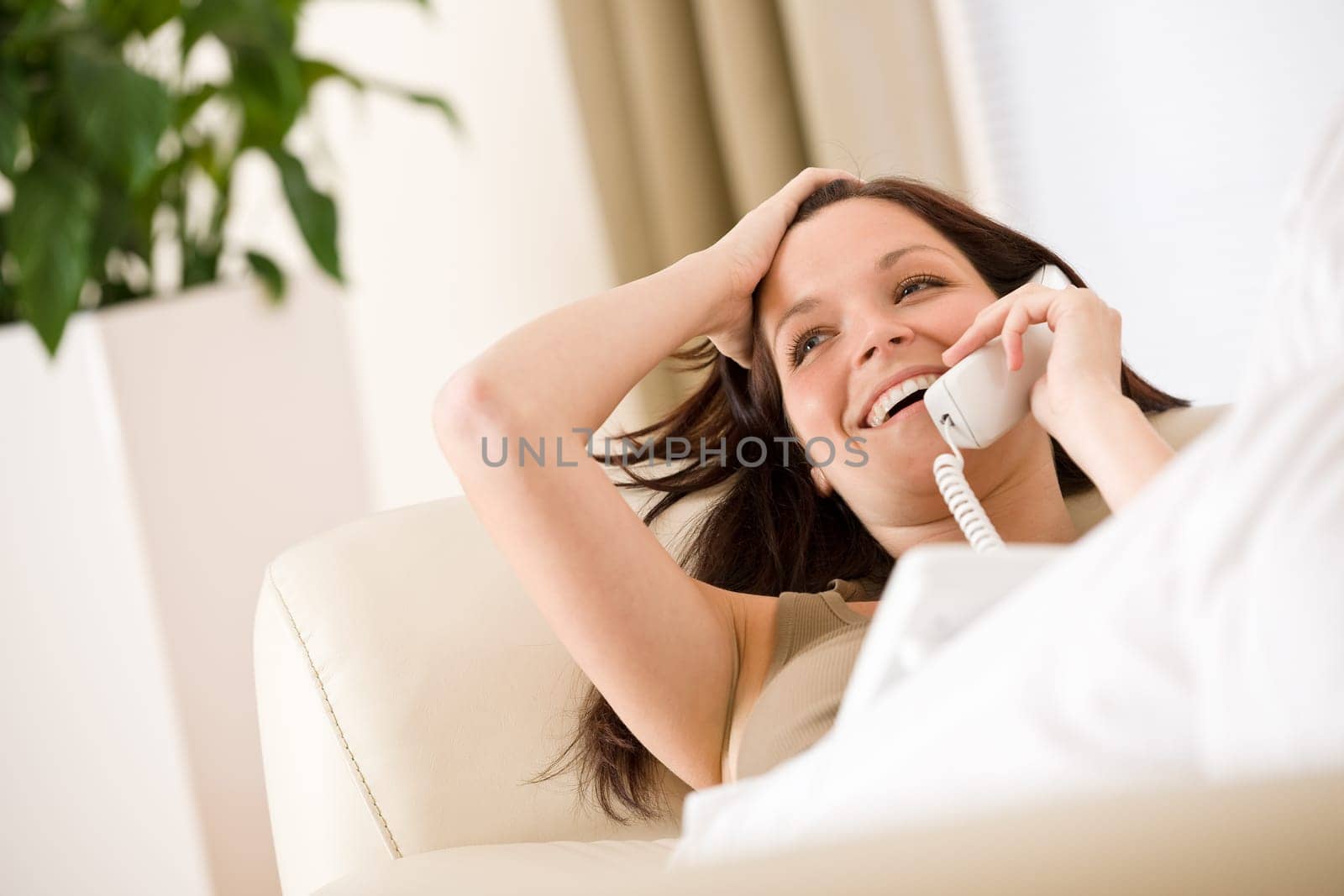 On the phone home Smiling woman calling