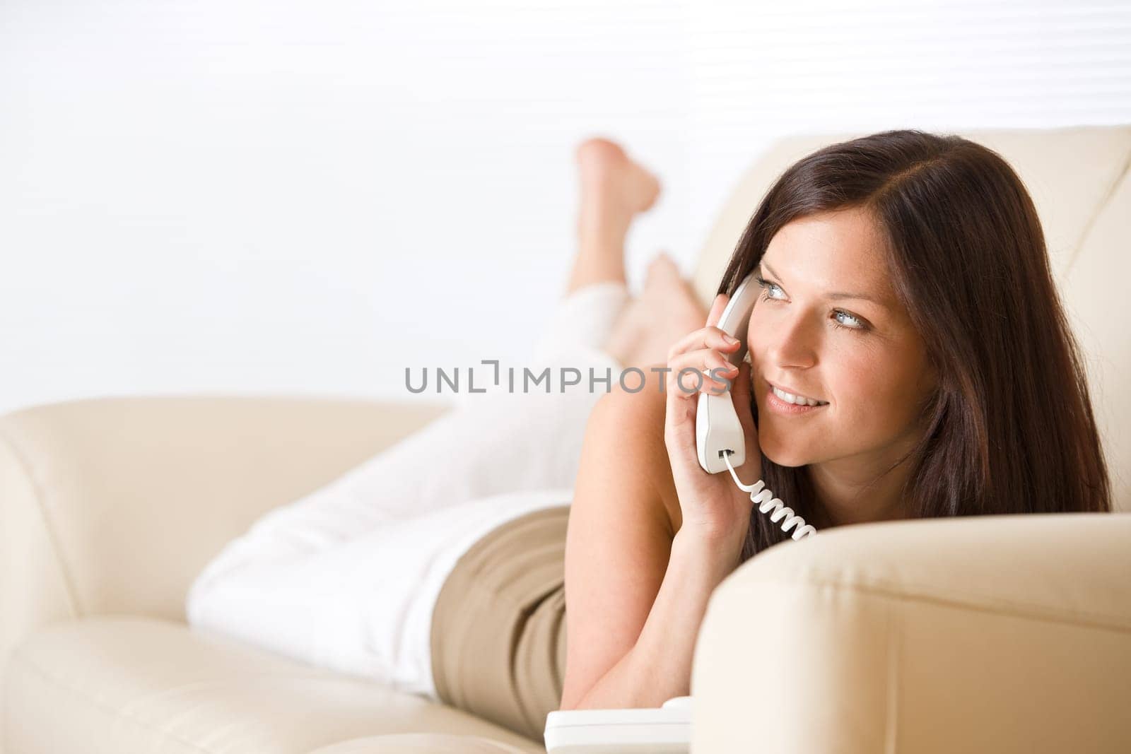 On the phone home Smiling woman calling